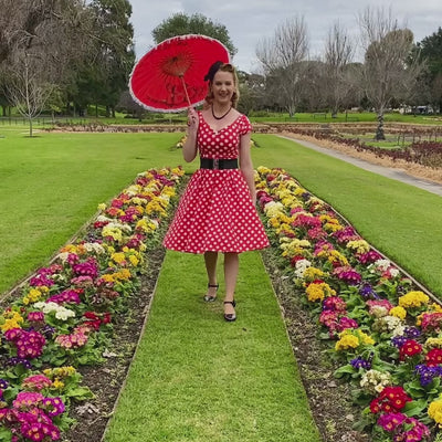 Video of our customer wearing our lily red and white polka dot spot print dress, whilst twirling her parasol