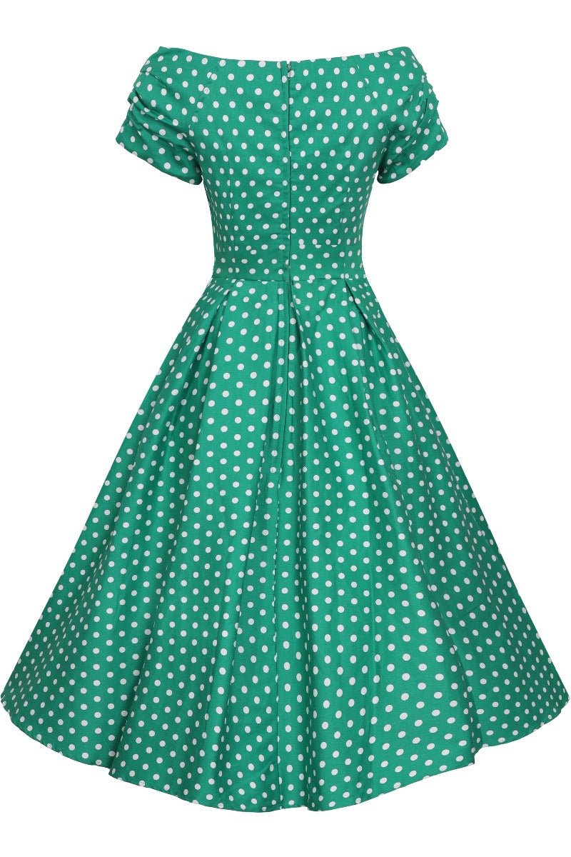 Short sleeved, flared dress, in green/white polka dot print, back view