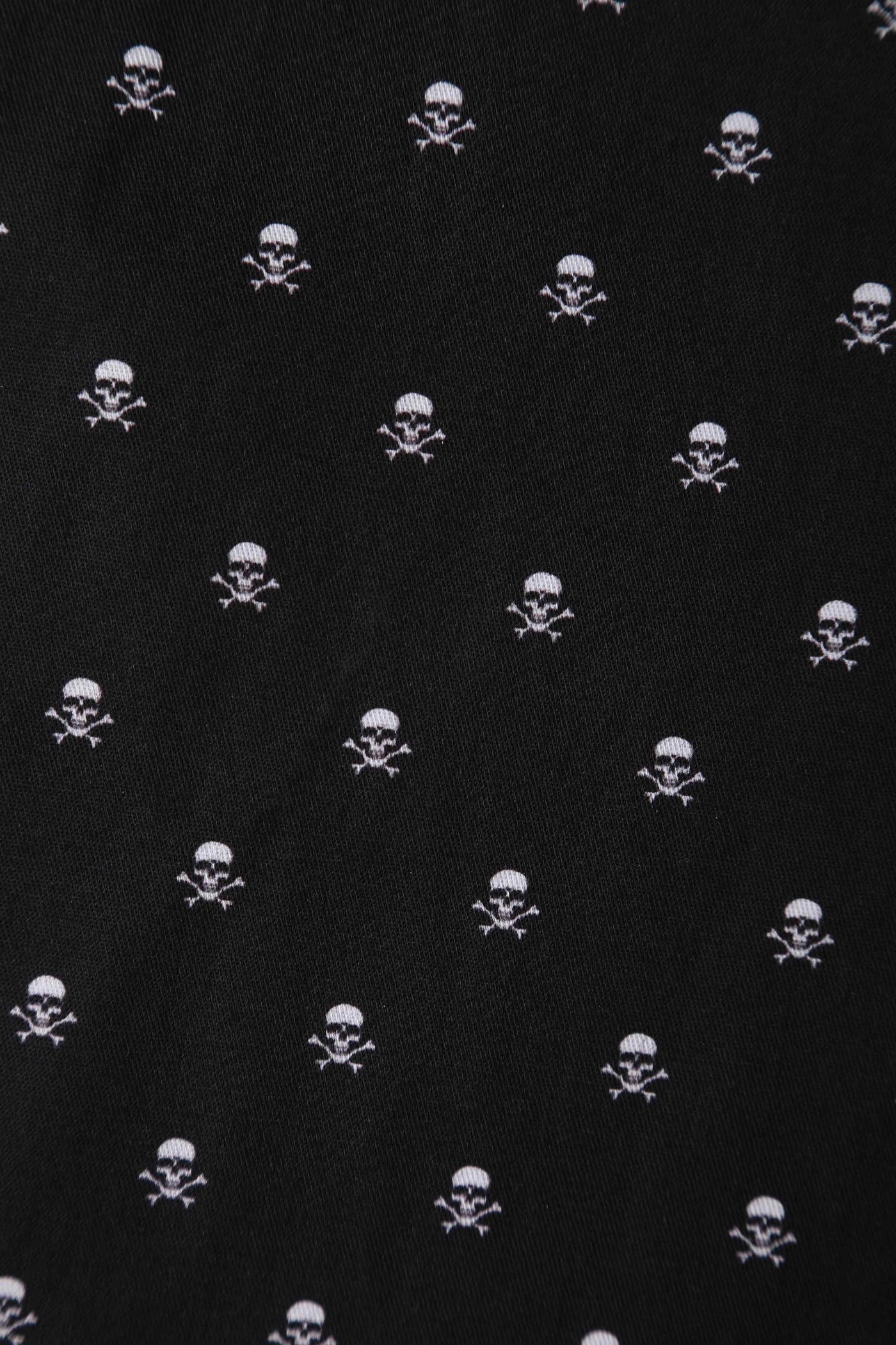 Close up fabric view of black skull print vintage style swing dress