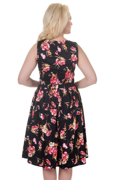Model wearing our sleeveless Annie dress in black/pink floral print, back view