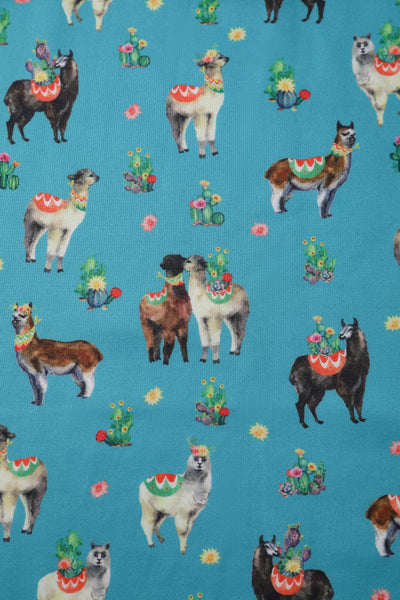 Fabric close up of our turquoise fabric, with llamas and cactuses