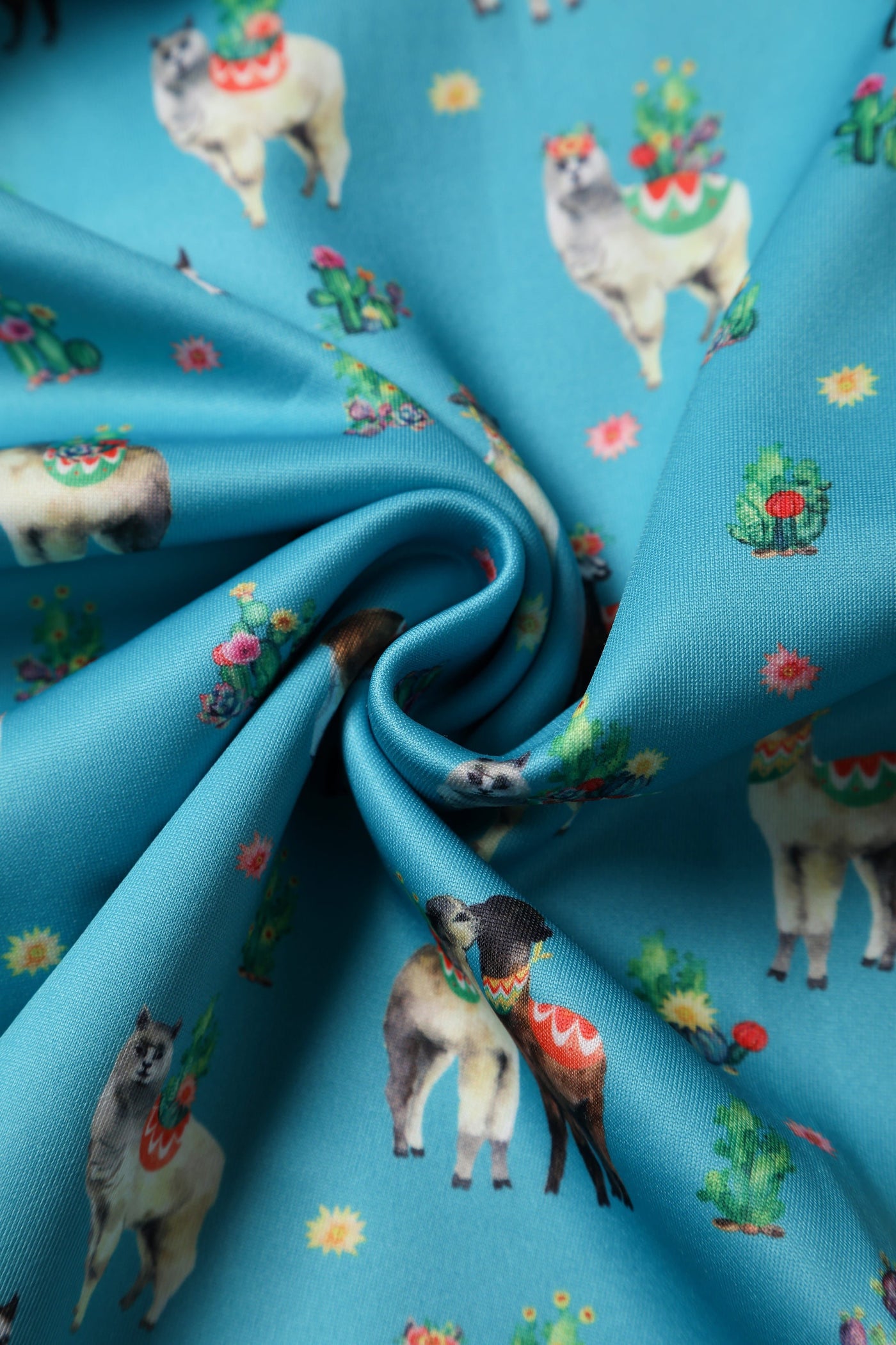 Fabric close up for our turquoise llama cactus print