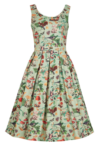 Front view of our sleeveless Amanda swing dress, in pastel green, with mushrooms, birds and squirrels print