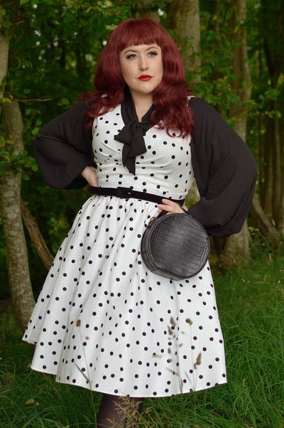 Influencer wearing white dress with black polka dots