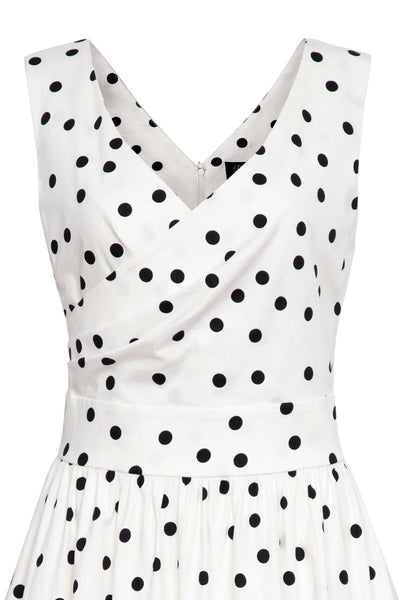 White wrap bust dress with black polka dots close up