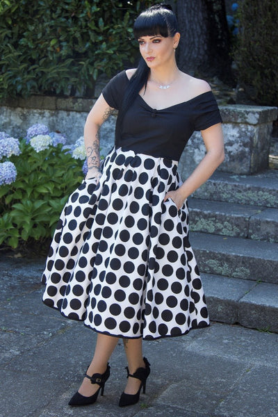 Influencer wearing black and white spot fit and flare dress
