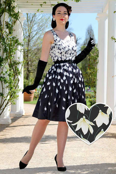 A model wearing a Amanda 50s Inspired Black Swing Dress & Snowdrops