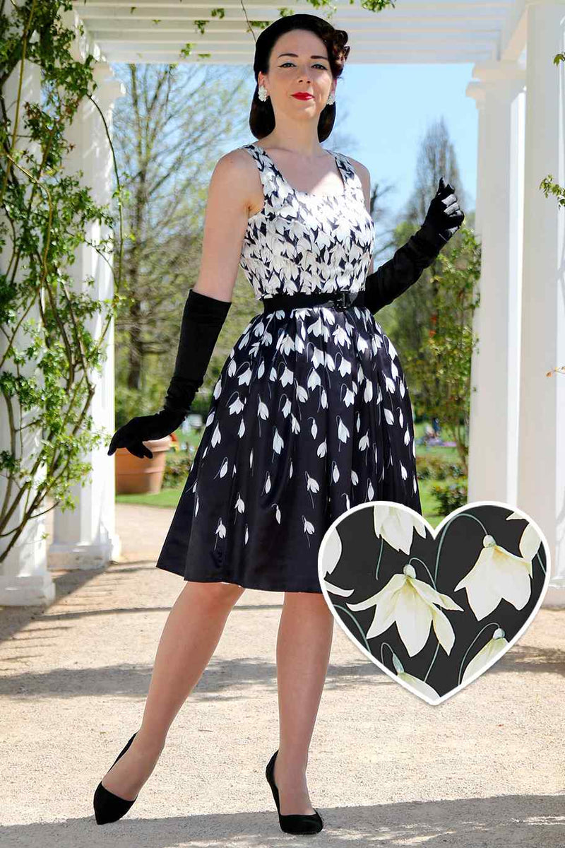 A model wearing a Amanda 50s Inspired Black Swing Dress & Snowdrops