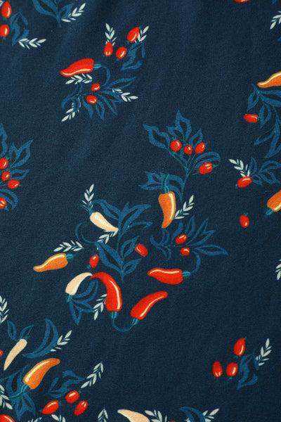 Fabric view of short sleeved blue midi dress, with red chili print