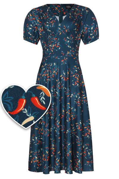 Front view of short sleeved blue midi dress, with red chili print