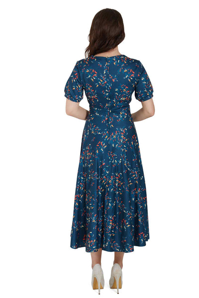Back view of woman wearing our short sleeved blue midi dress, with red chili print