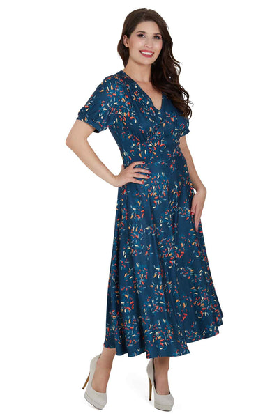 Side view of woman wearing our short sleeved blue midi dress, with red chili print
