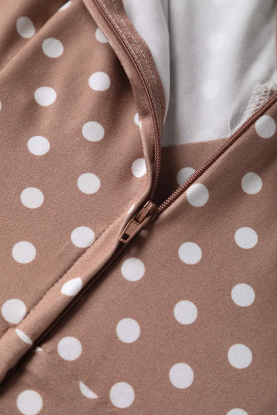 Close up view of 50s style brown and white polka dot swing dress