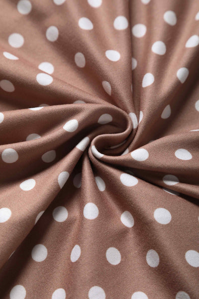 Close up view of 50s style brown and white polka dot swing dress