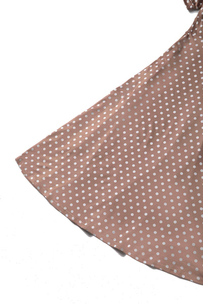 Close up view of 50s style brown and white polka dot swing dress