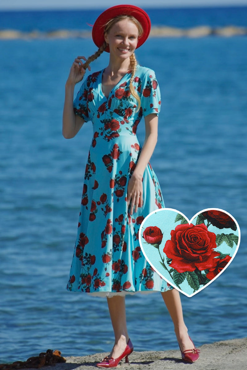 A lady wearing a 50s Style Red Rose Sleeved Dress in Blue