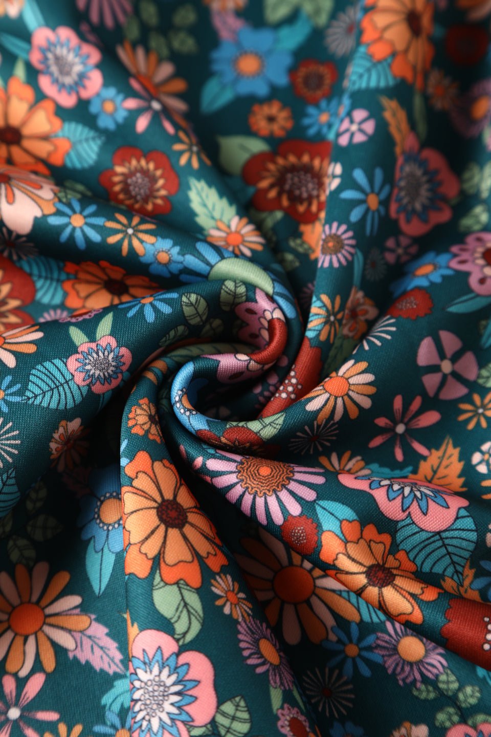 Close up view of 70s Floral Swing Dress In Peacock Blue