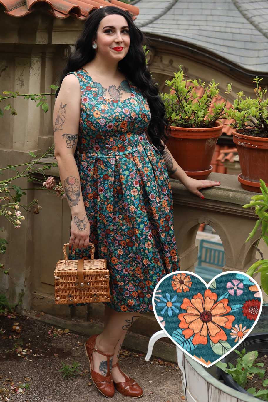 A model wearing an Amanda 70s Floral Swing Dress In Peacock Blue