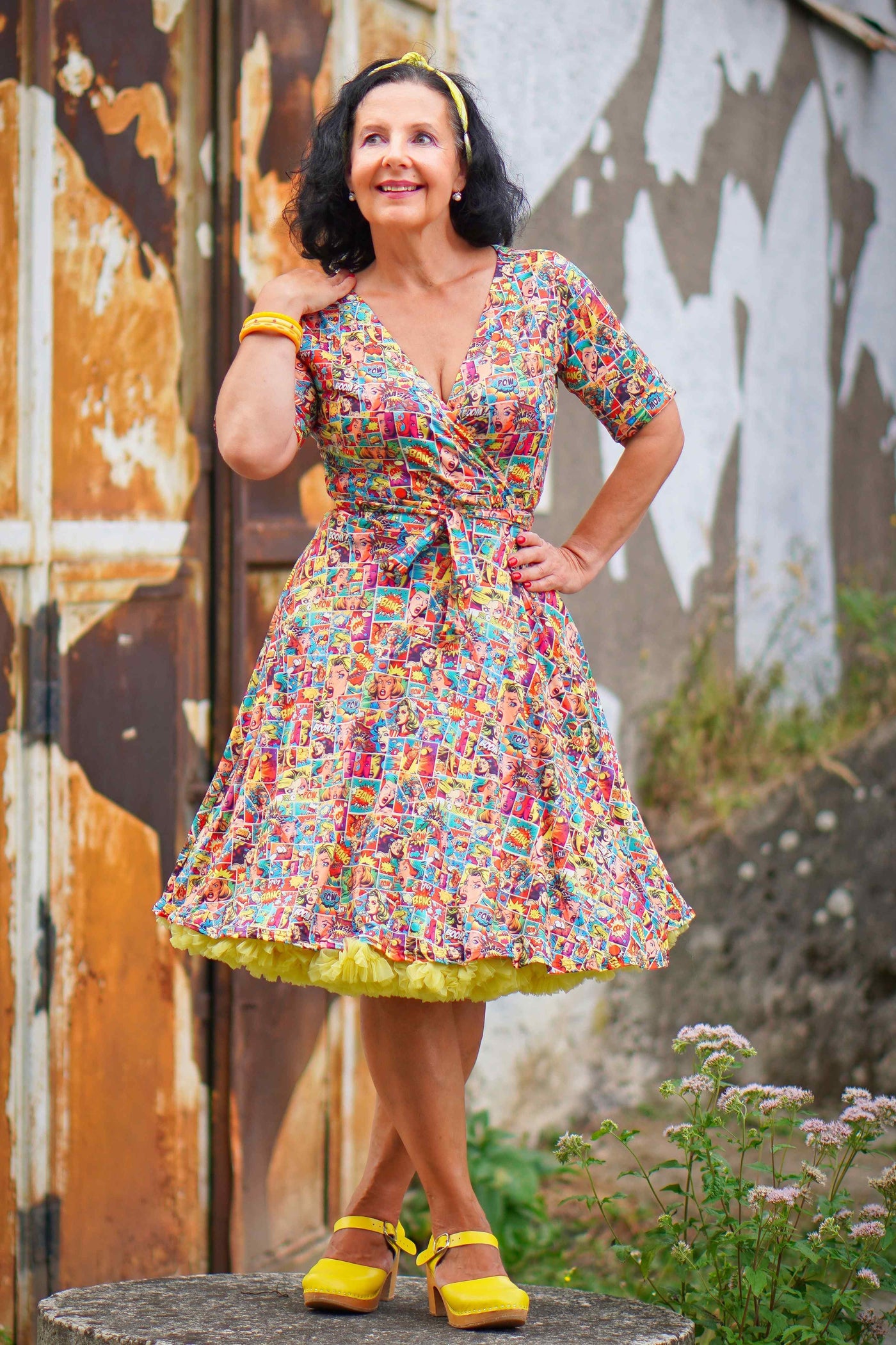 A lady wearing a Matilda Comic Wrap Dress