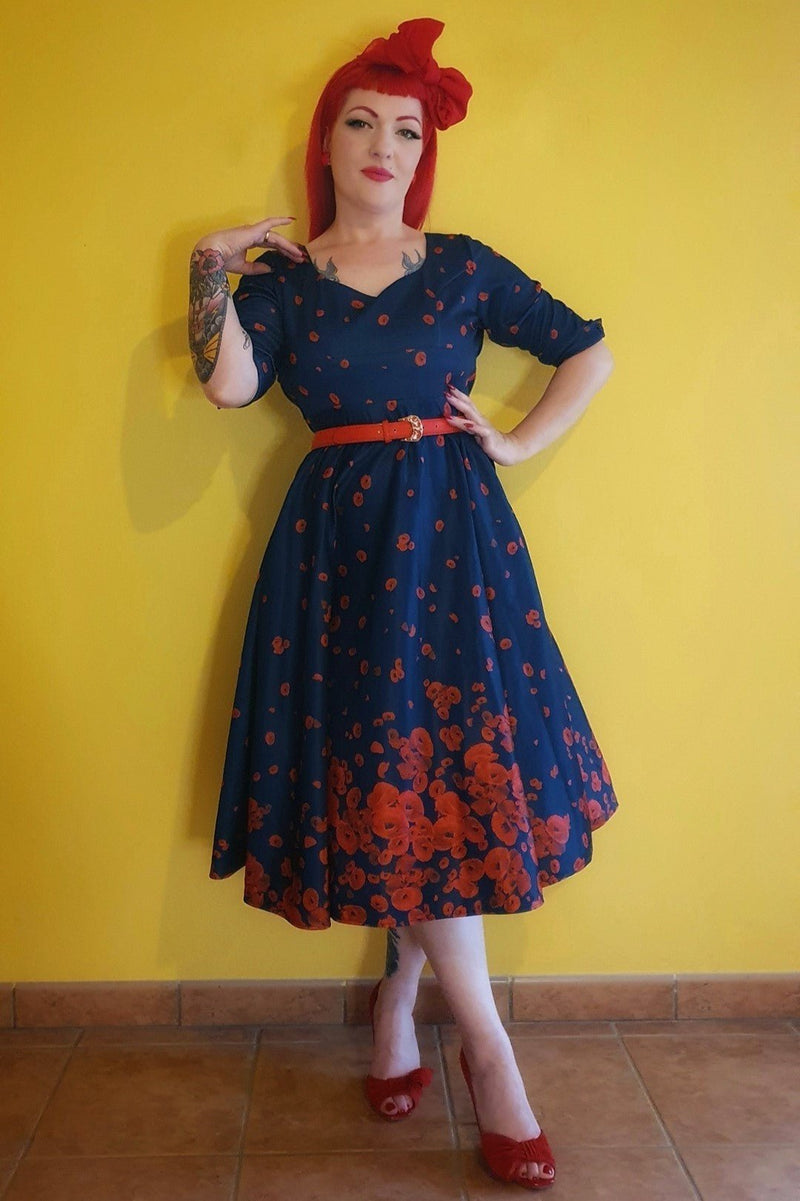 A model wearing Long Sleeved Midi Dress in Navy & Red Poppy