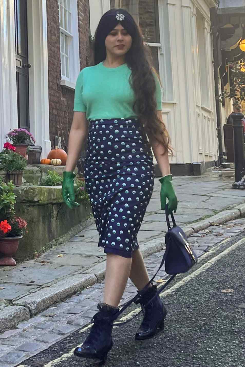 A model wearing Navy Pencil Skirt With White & Green Polka Dots