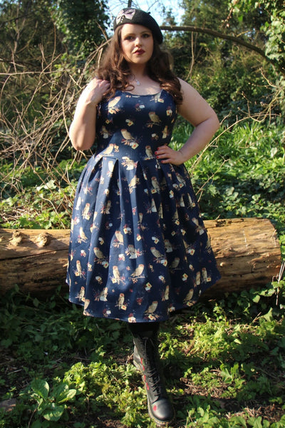 A lady wearing a Owl & Letter Swing Dress in Dark Blue