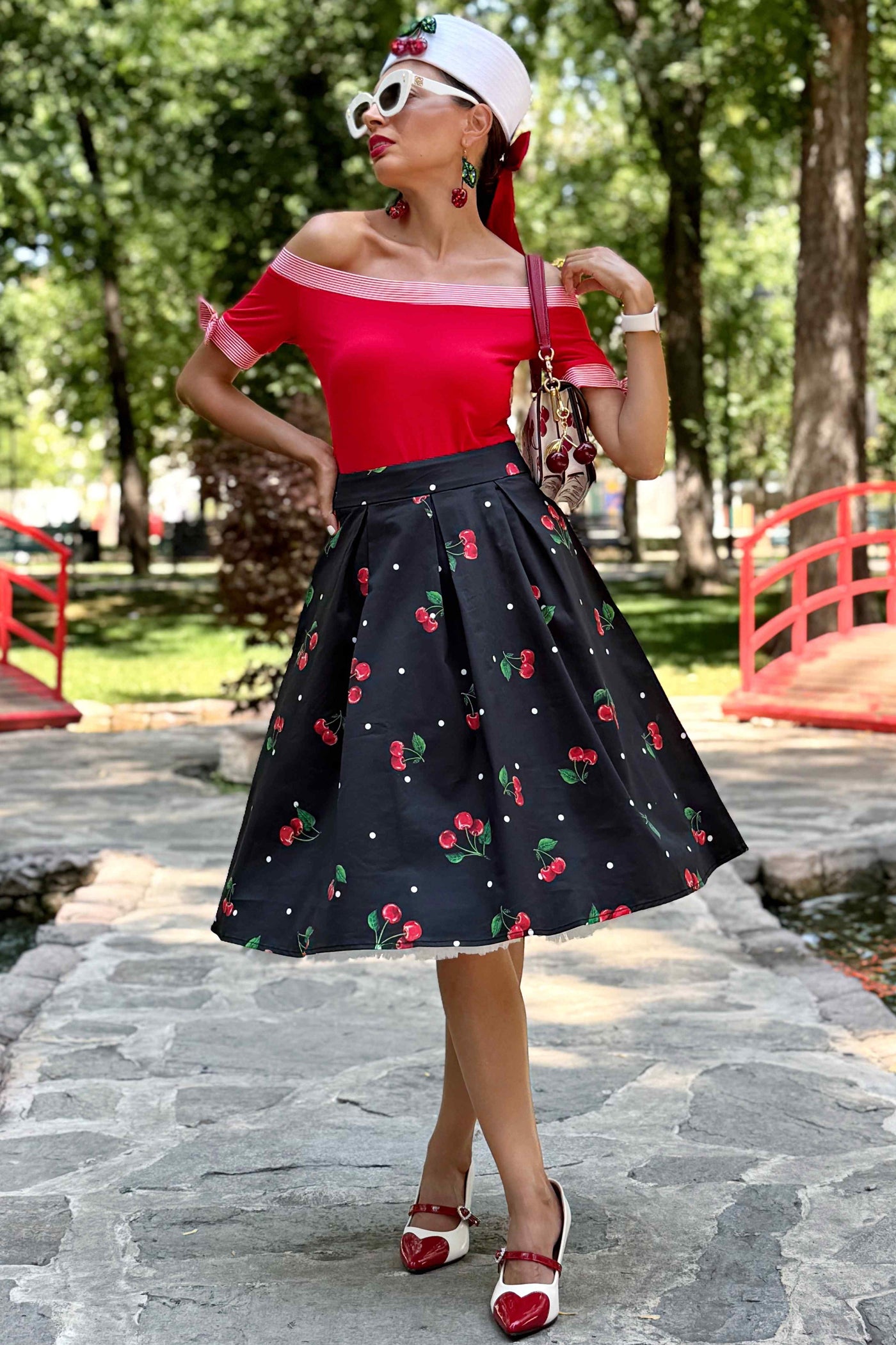 A model wearing a Carolyn Polka Dot Cherry Black Flared Skirt