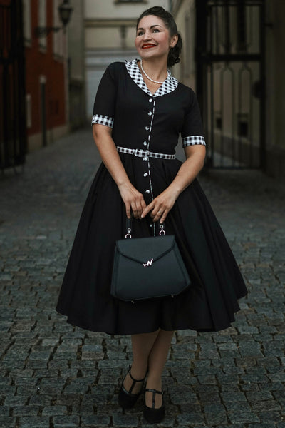 A woman wearing a Mollie Black Full Circle Shirt Dress With Gingham