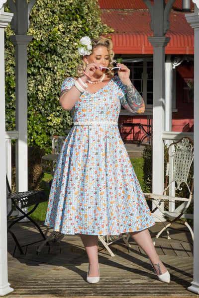 A model wearing Blue Gingham Off Shoulder Dress In Baking Print