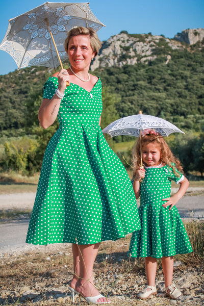 Mom and daughter wearing the Darlene dresses dark green polka dot dress