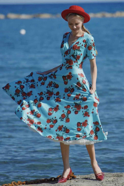 A lady wearing a 50s Style Red Rose Sleeved Dress in Blue
