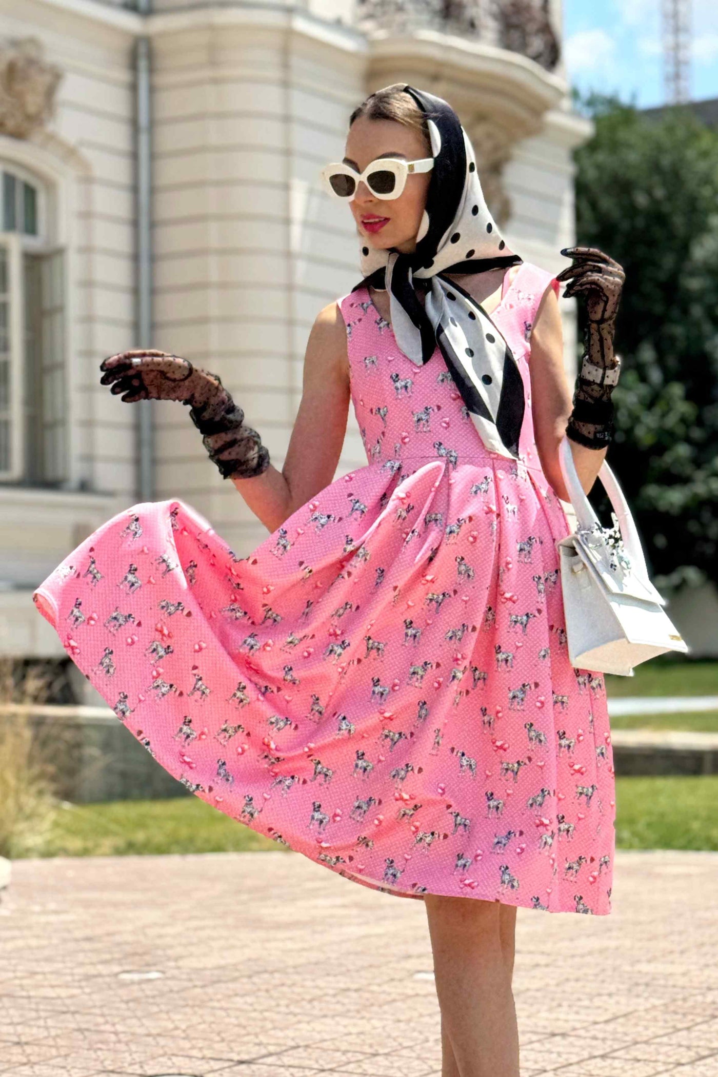 A lady wearing a Amanda Pink Dalmatian Flared Dress