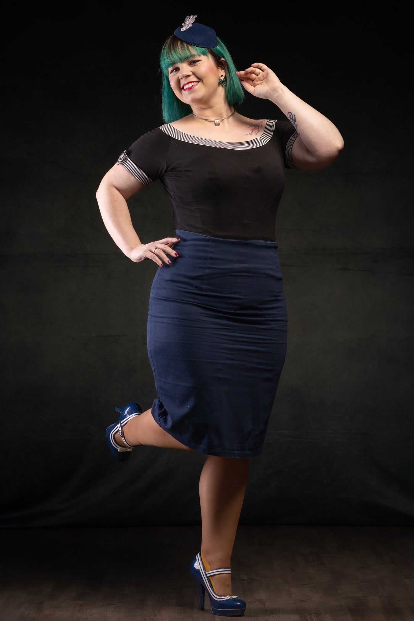 Customer wears our short sleeved round neck top, in black, with stripe trims, front view