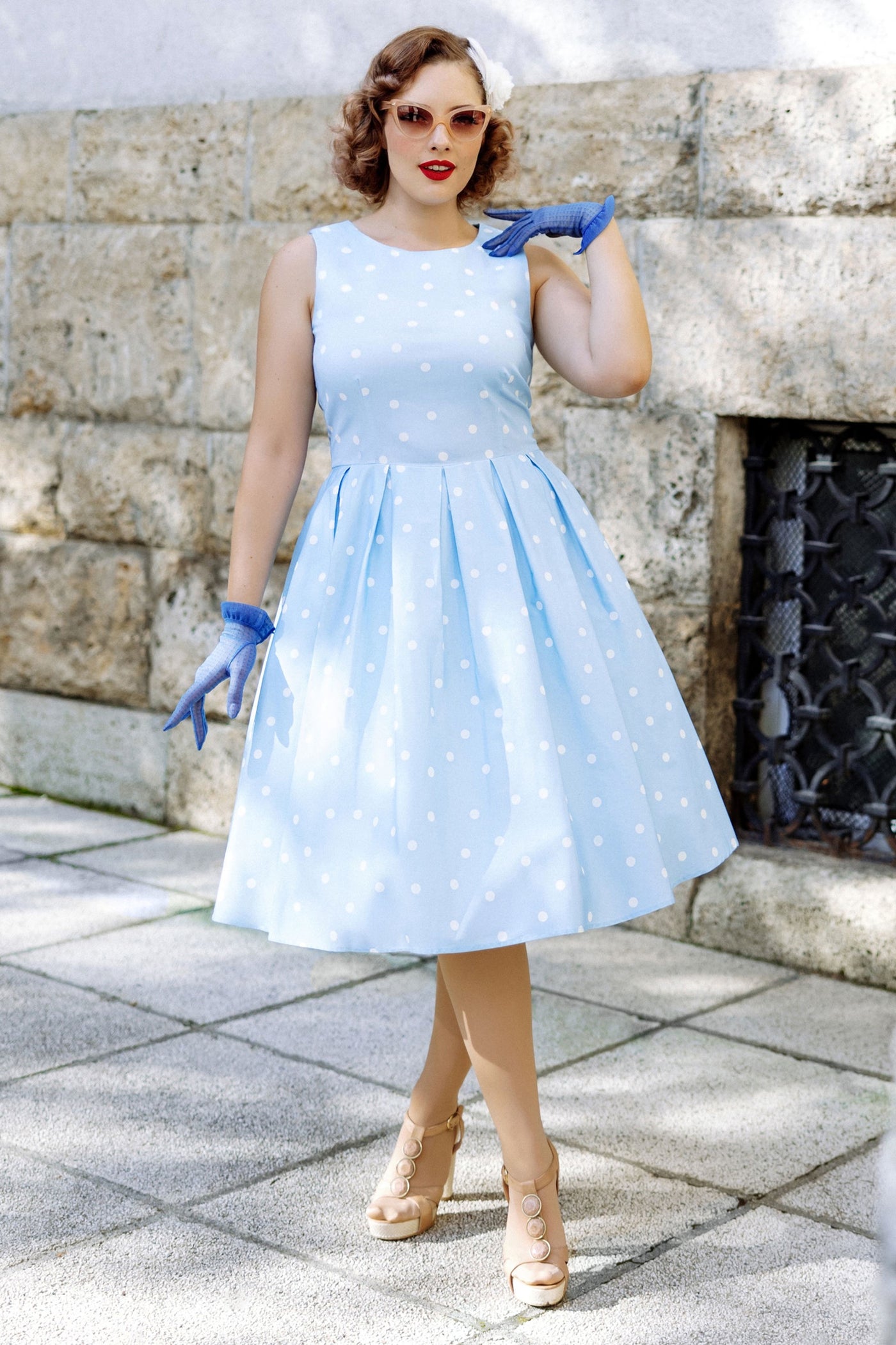 A lady wearing a Baby Blue Polka Dot Swing Dress