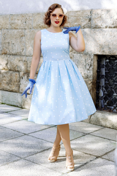 A lady wearing a Baby Blue Polka Dot Swing Dress