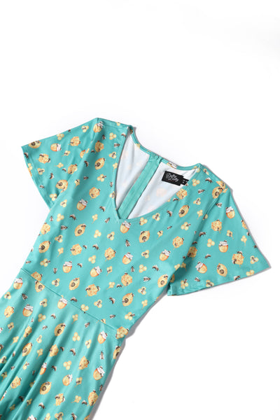 Top view of green honey and bee print dress with short sleeves