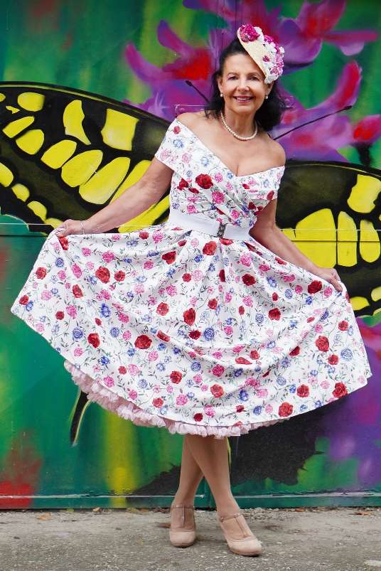 A lovely model wearing a Beverly Rose Off Shoulder Dress In White