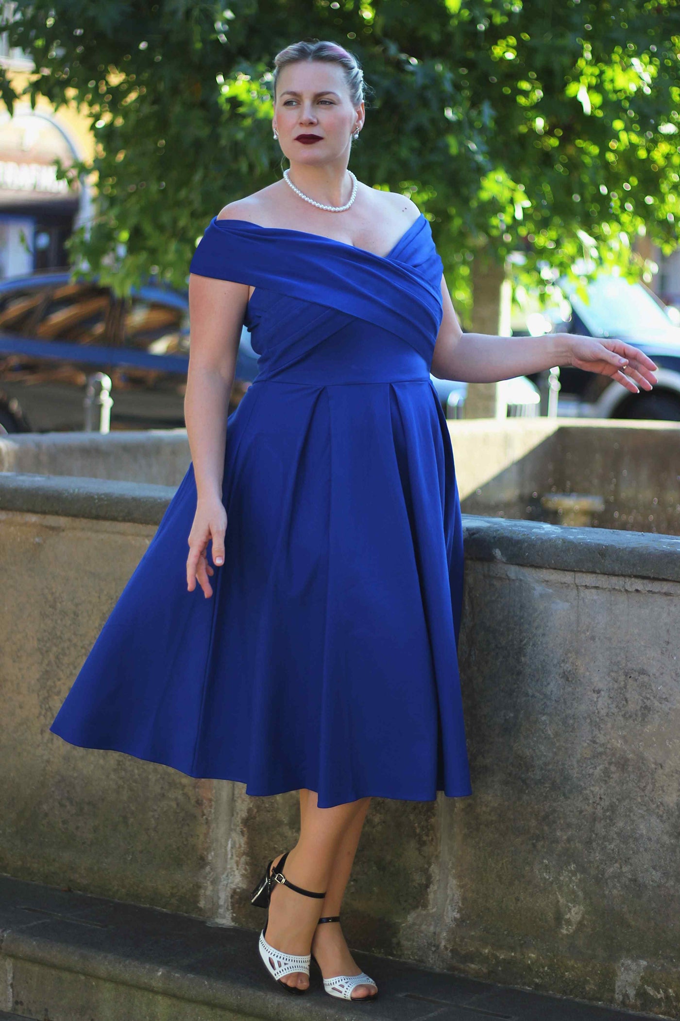 A charming model wearing a Beverly Royal Blue Off Shoulder Dress