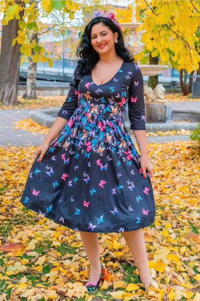 A model wearing a Billie Black Butterfly Long Sleeved Dress