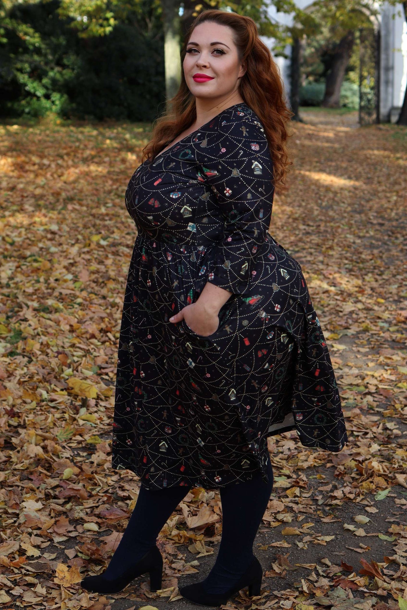 A lady wearing a Billie Christmas Print Long Sleeved Dress