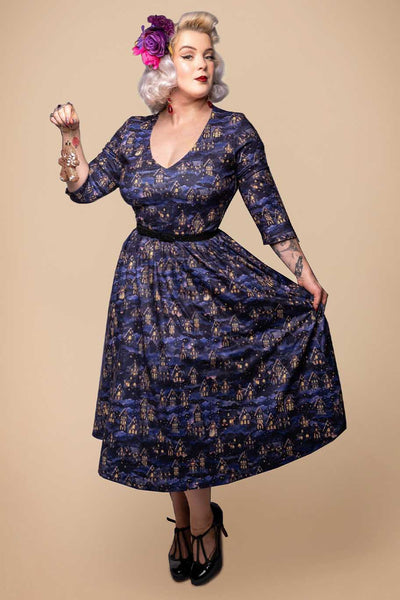 A lady wearing a Billie Purple Christmas Eve Flared Dress