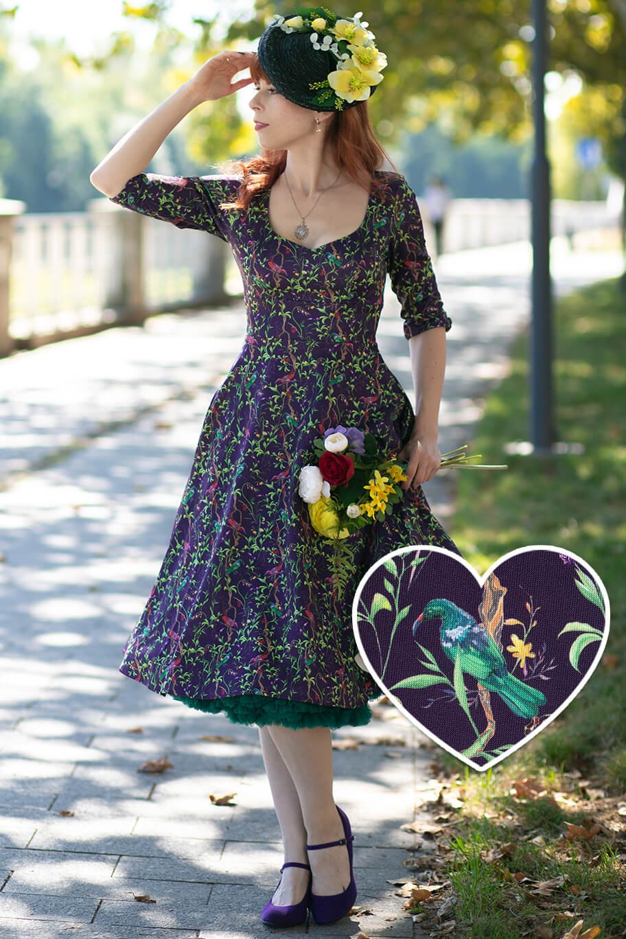 A lovely model wearing a Scarlette Bird & Floral Midi Dress On Purple