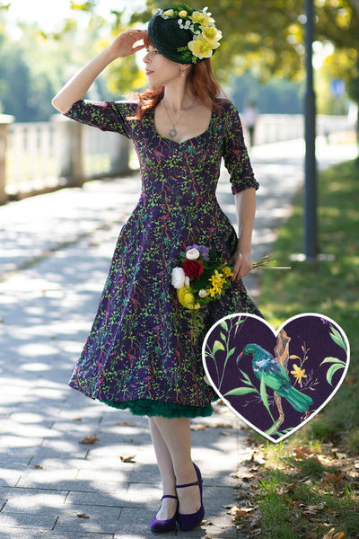 A lovely model wearing a Scarlette Bird & Floral Midi Dress On Purple