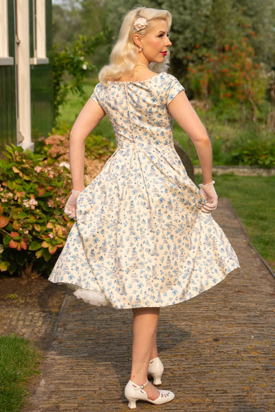 Model wearing a Bird Cage Off Shoulder Dress In Cream White