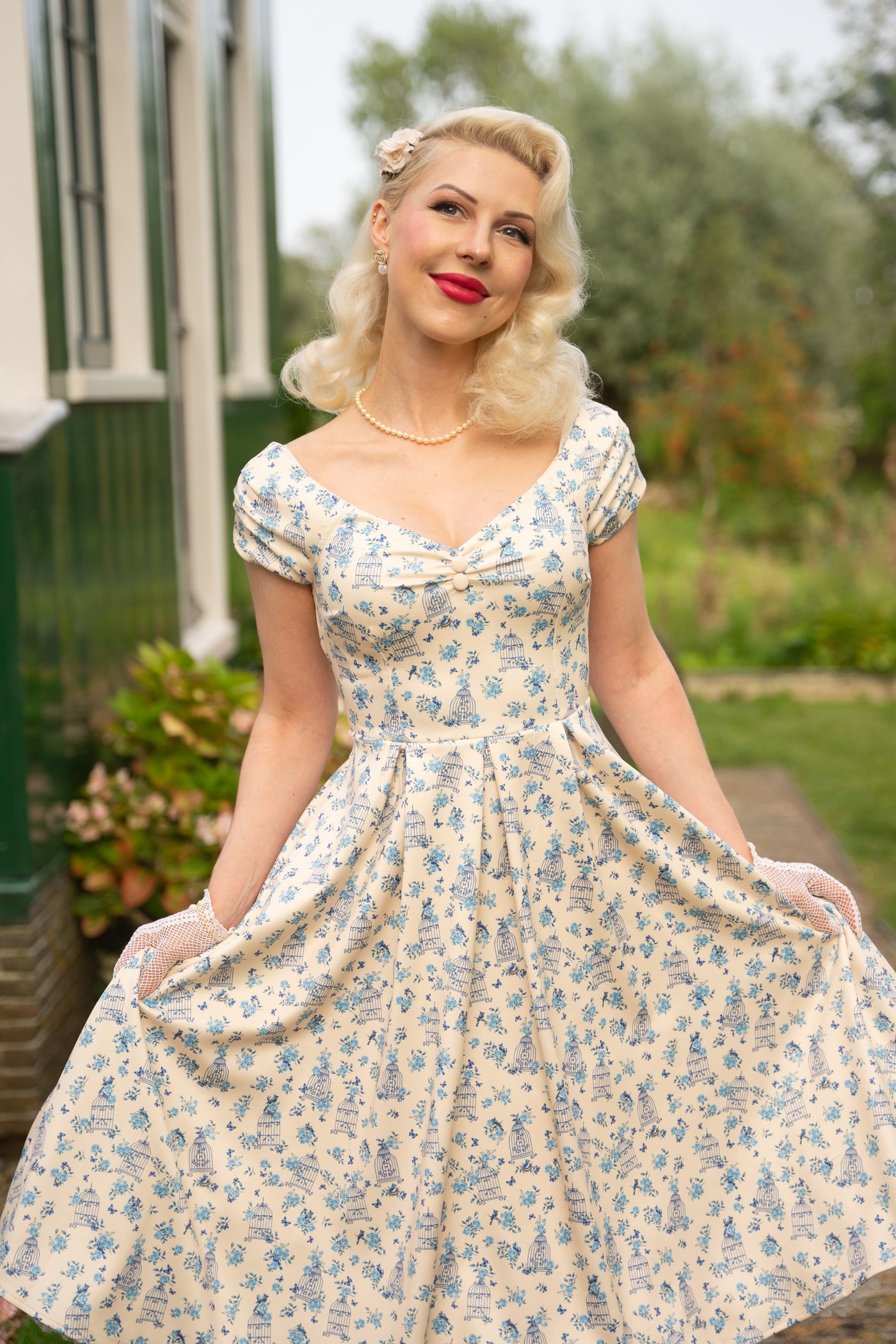 Model wearing a Bird Cage Off Shoulder Dress In Cream White