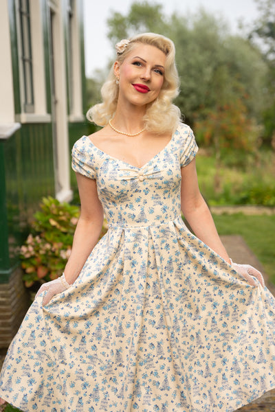 Model wearing a Bird Cage Off Shoulder Dress In Cream White