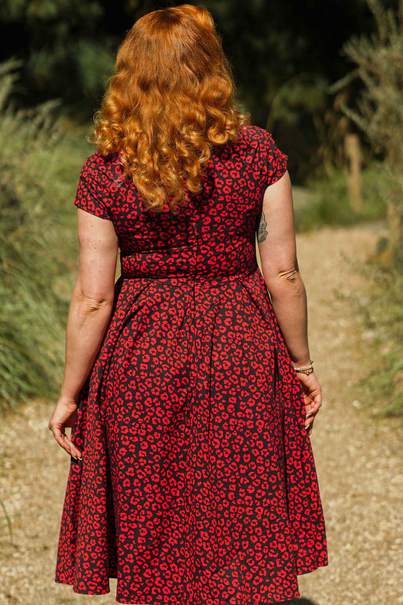 A model wearing a Black & Red Cheetah Print Off Shoulder Dress