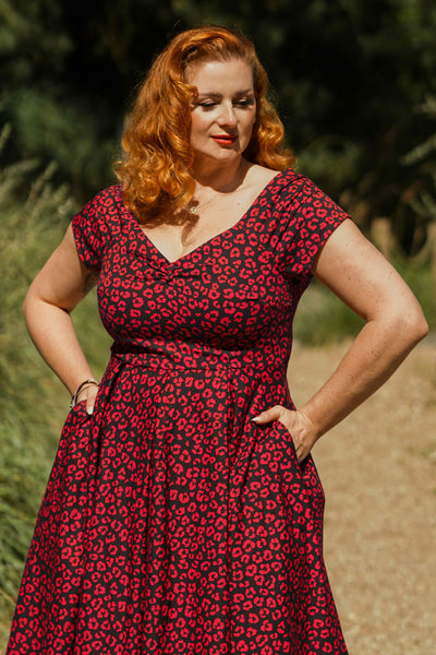A model wearing a Black & Red Cheetah Print Off Shoulder Dress