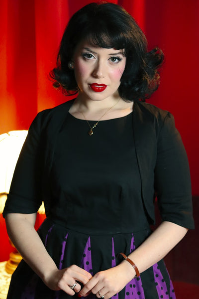 A model in Lisette Black Bolero Jacket