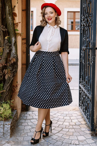 A model wearing a Monochrome Polka Dot Swing Skirt and Black Bolero Jacket